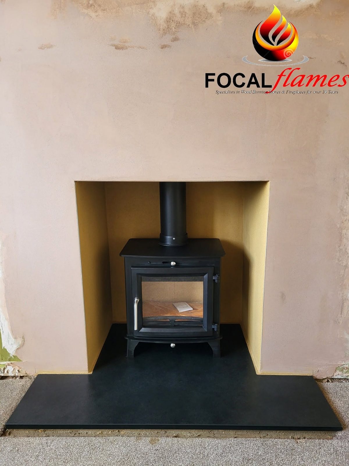 A stove in a freshly plastered recess on a slate hearth