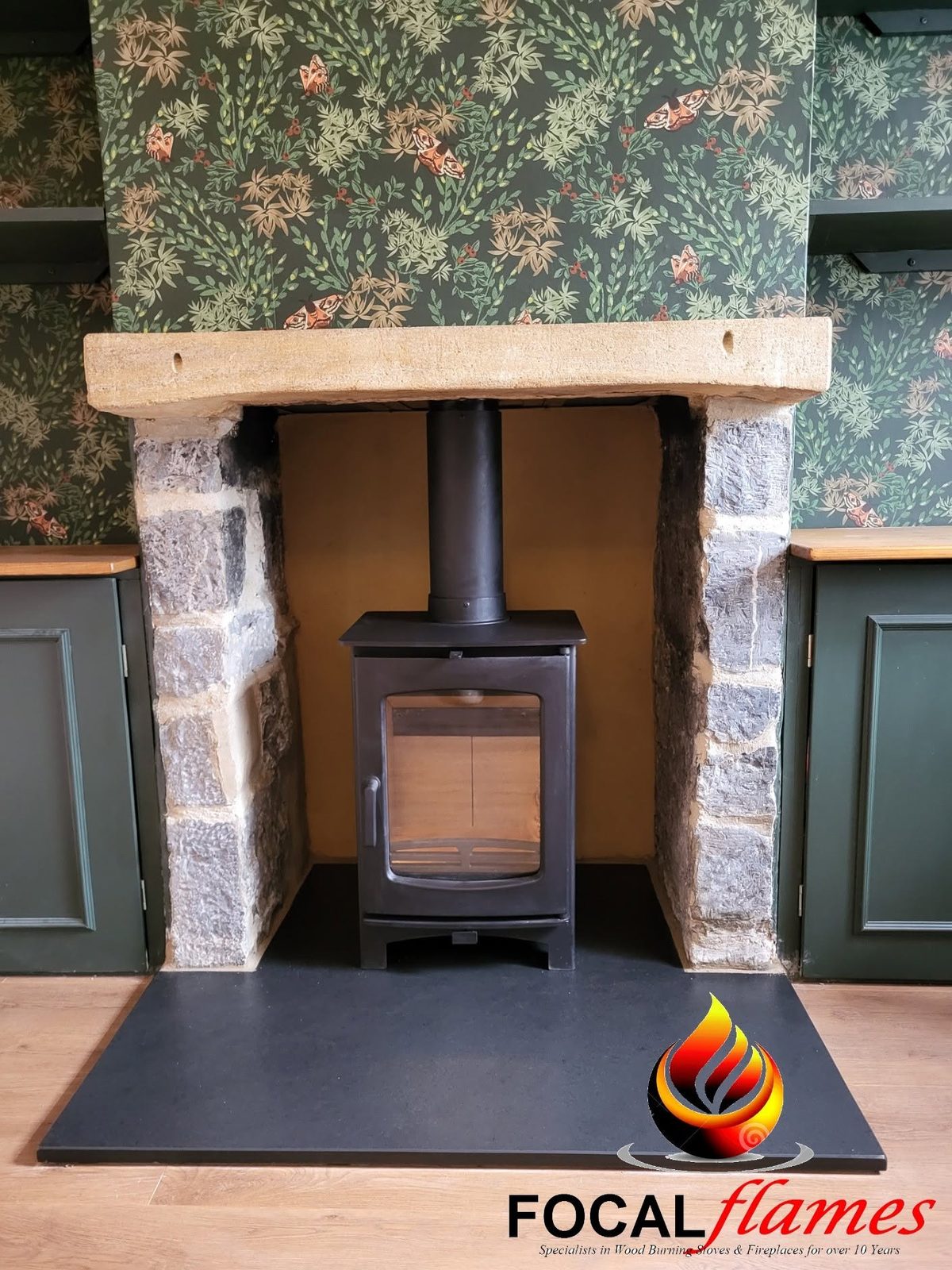 After: the recess opened up with a new wood burner under the oak beam on a slate hearth