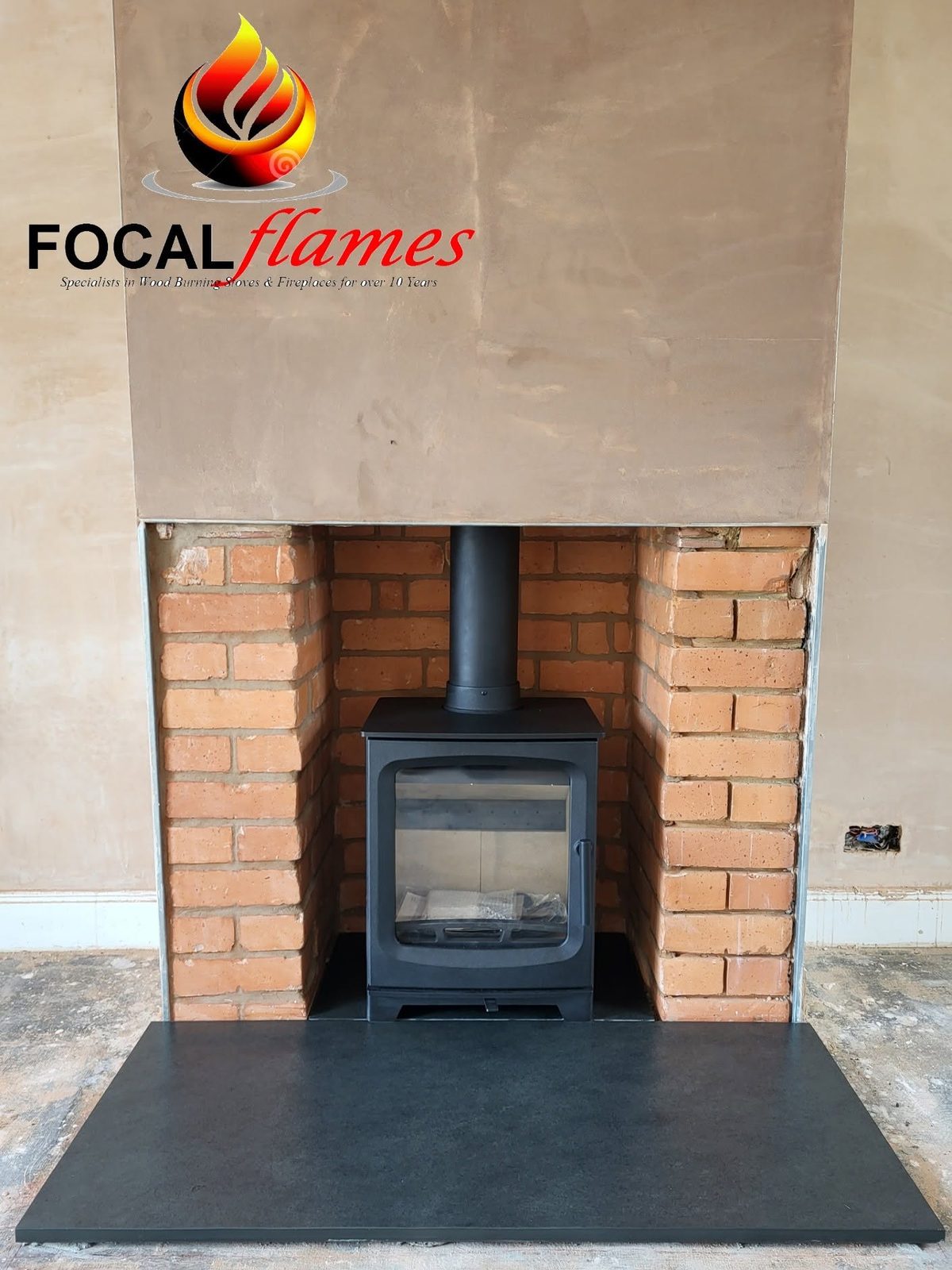 A stove in an exposed red brick recess