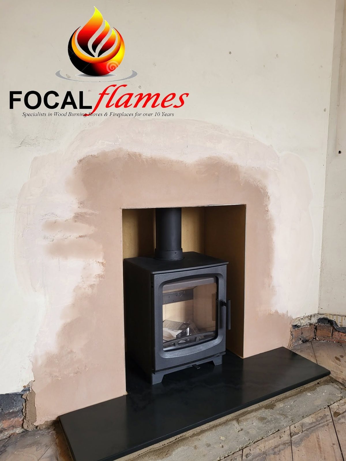 A stove in place while the new plaster round the recess dries