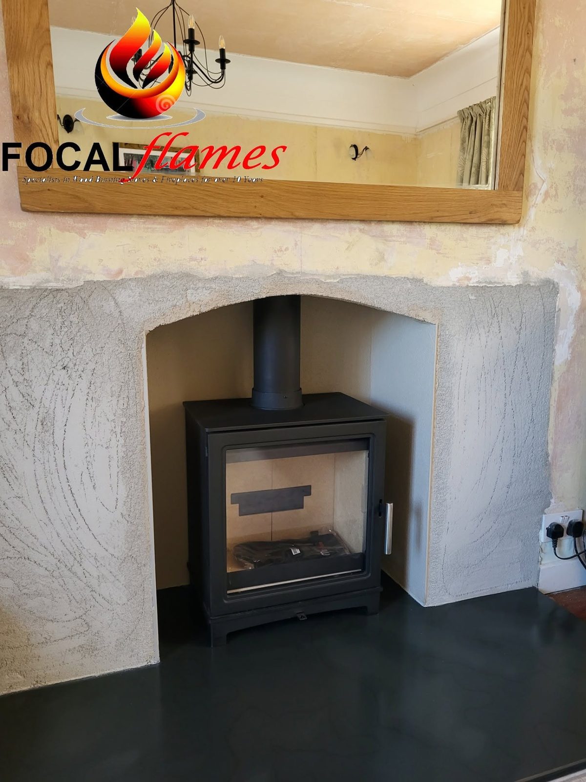A stove in an arched surround below a mirror