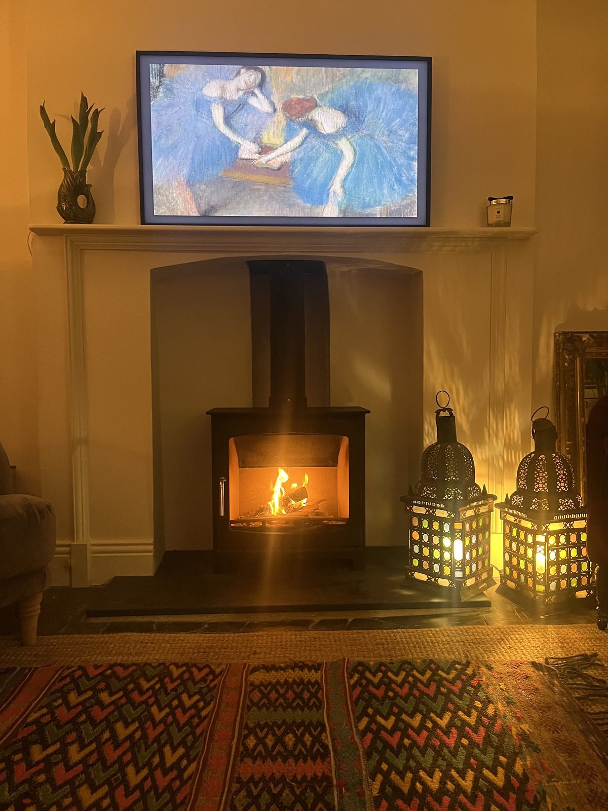 A customer's stove lit in its recess, lanterns either side